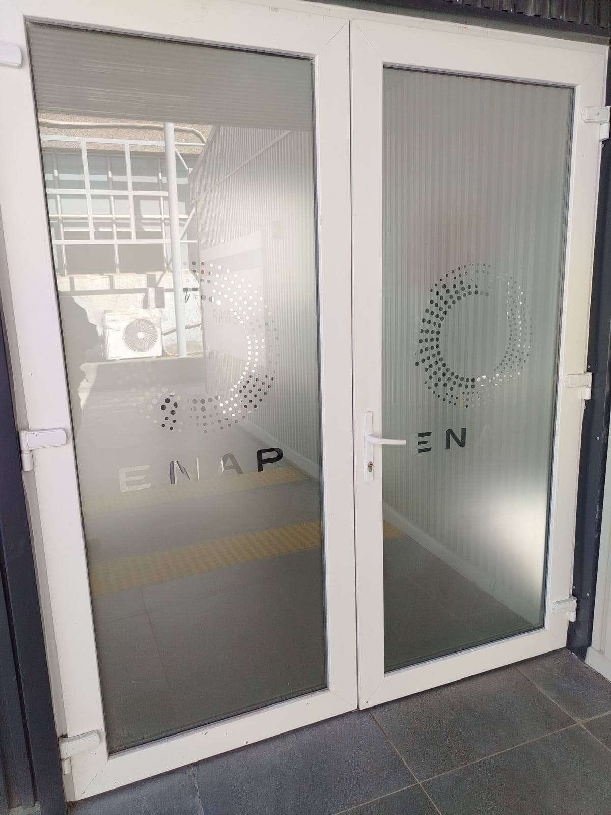 Vinilo empavonado instalado en puertas de acceso
