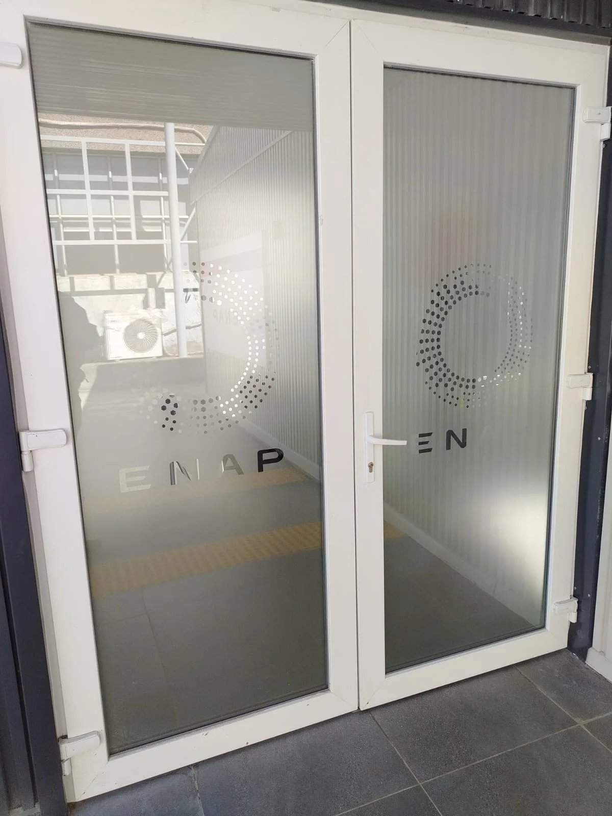 Vinilo empavonado instalado en puertas de acceso